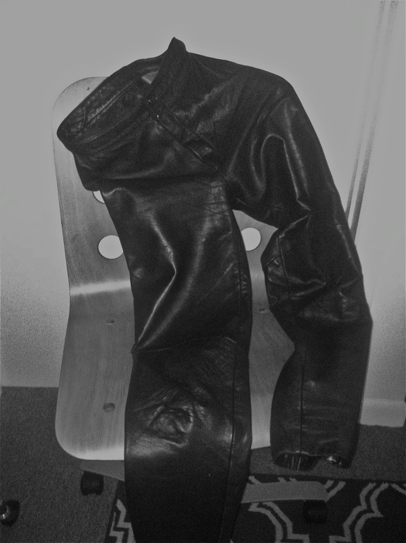 Black Leather Pants draped over a wooden chair