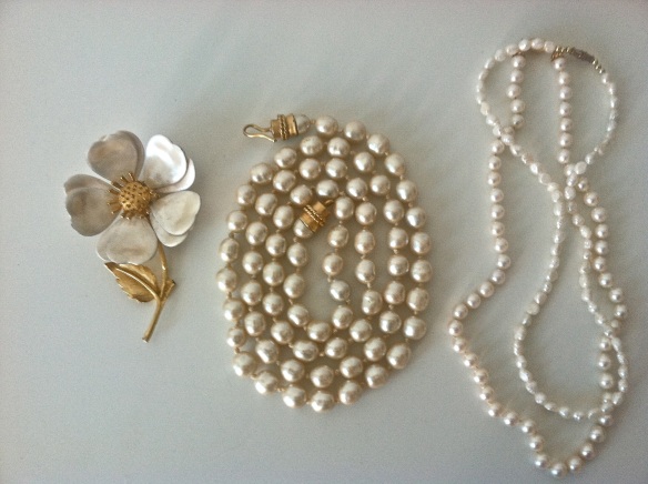 A flower pin, coiled pearl necklace and 2 strands of pearls