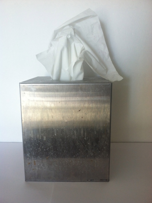 Kleenex in a silver colored tissue box